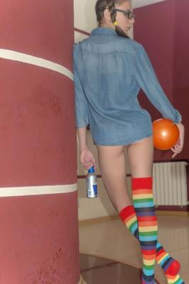 cute teen Rimma playful with rainbow socks, glasses and pigtails